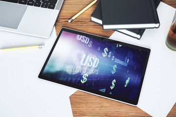 Top view of modern digital tablet monitor with creative USD symbols hologram. Banking and investing concept. 3D Rendering