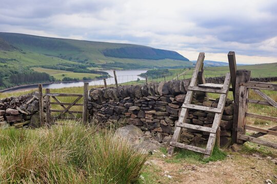 dry stone wall with gate and stile steps ladder countryside view 