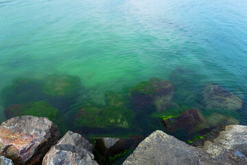 View of the sea water from the shore in the stones