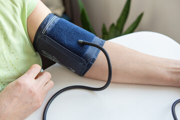 Measurement of blood pressure. A device for measuring blood pressure on a woman's hand.