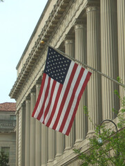 Washington, DC, USA - April 25, 2004: Flag displayed outside of the United States Department of Commerce Building - obrazy, fototapety, plakaty