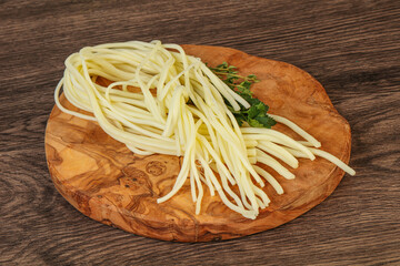 Chechil spaghetti cheese over board