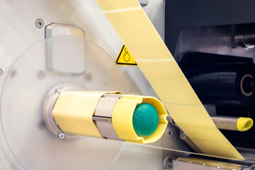 Fragment of the conveyor of sticking labeling machine. Abstract industrial background.