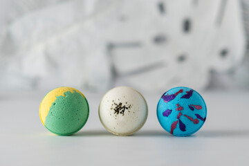 Colourful bath bombs on white textured background. Beauty products for body care.