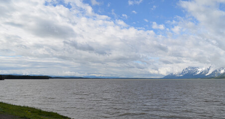 Late Spring in Grand Teton National Park: Looking South Across the Water at a Cloud-filled Sky and the Teton Range from Jackson Lake Overlook