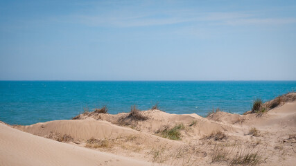 Fototapeta na wymiar Dunas white sand hills near blue sea. High quality photo