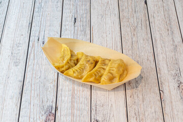 Wooden fence tray with raion of Japanese steamed dumplings gyozas