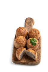 Mini Melton Mowbray pork pies with one halved isolated on white background