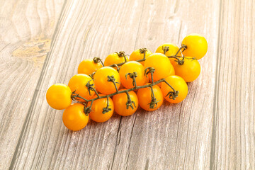 Branch with yellow cherry tomato