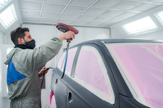 Man Polishing Car With Sandblasting Gun In Service