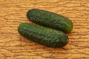 Green fresh cucumbers over background