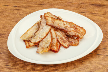 Roasted juicy bacon in the plate