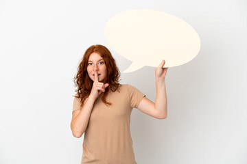Teenager redhead girl isolated on white background holding an empty speech bubble and doing silence gesture