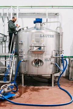 Brewer checking up lauter tun at work in beer factory