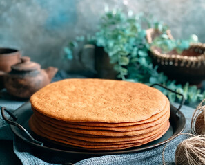 Cooking honey cake at home. Round baked cake layers stacked on plate.