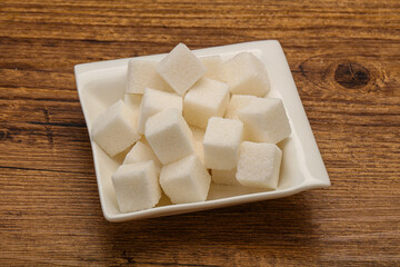 Refined white sugar cubs in the bowl