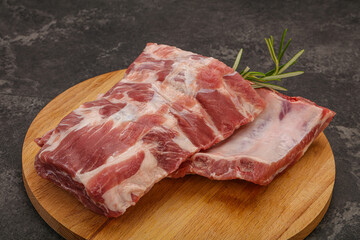 Raw pork ribs served rosemary