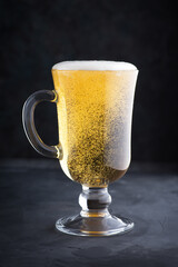Fresh light cold beer. Beer with foam in a pub. Alcohol drink. Macro photography. Close-up photo.
