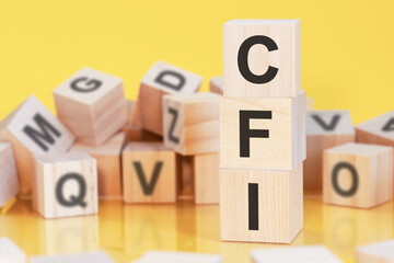 word cfi from wooden blocks with letters, concept