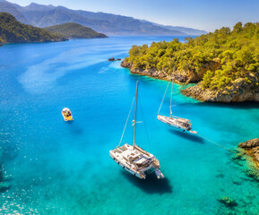 Aerial view of beautiful yachts and boats on the sea at sunset in summer in Turkey. Top view of...