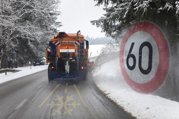 snow plow, winter service on a wet road, winter service truck driving on asphalt road at day while...