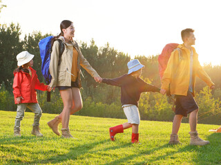 A Happy family of four outdoor hiking