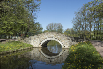 An ancient bridge over the river in the city park