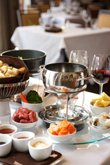 Fondue plate at a restaurant.  Cheese, traditional oil, and chocolate fondue