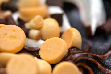 Macro close up on a profiterol ice cream with vanilla and chocolate 
