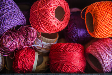 Many balls of yarn, reds.