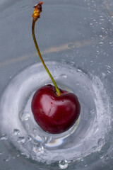 red cherry on the blue background with drops