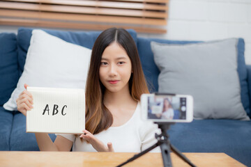 Young asian woman is teacher teaching language english with student for e-learning online at home,...