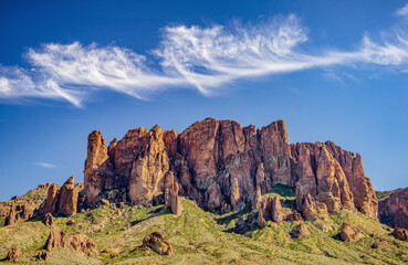 wispy clouds over desert mountain range