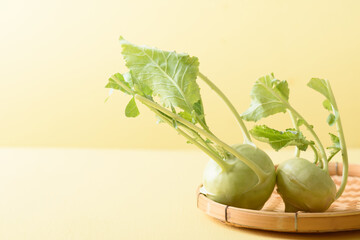 Fresh kohlrabi on yellow background, organic vegetable ingredient for vegan food, healthy eating...