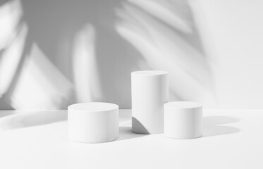 A white cylinder is placed on a white background. A stage for displaying products and cosmetics.
