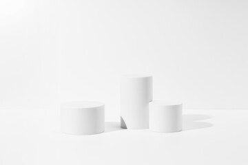 A white cylinder is placed on a white background.