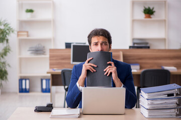 Young male employee working in the office