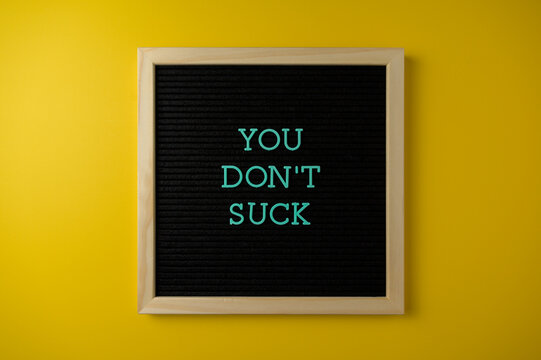 You Don't Suck Sign on Yellow Background