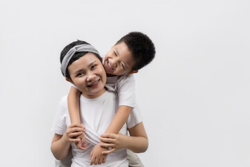 Young adult female cancer patient spending time with little son on gray background. Cancer and family support concept.