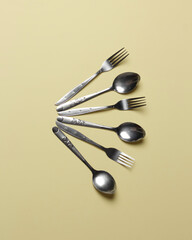 Aluminum spoon isolated on yellow background. A spoon with a simple motif.