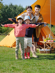 Happy family of four in the park