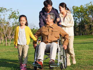 A happy family of four walking in the park