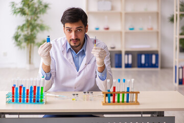 Young male chemist working at the lab in vaccination concept