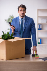 Young male employee in business relocation concept