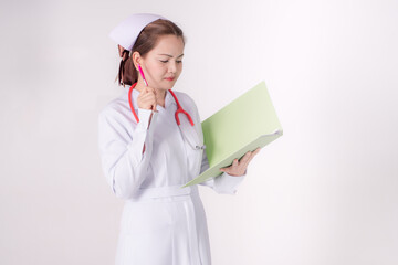 Asian nurse look at notepad to see work schedule and her patient..
