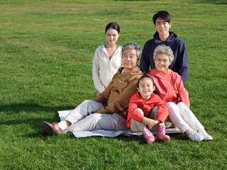 Naklejka na ściany i meble Happy family of five in the park