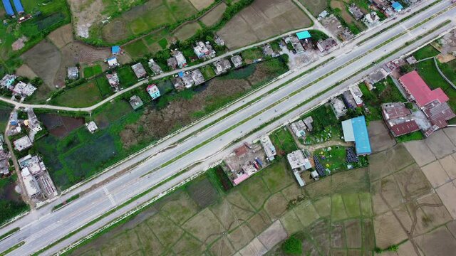 Diagonal View Of Siddhartha Highway With Vehicles Driving At Daytime In Bhairahawa, Nepal. aerial top-down