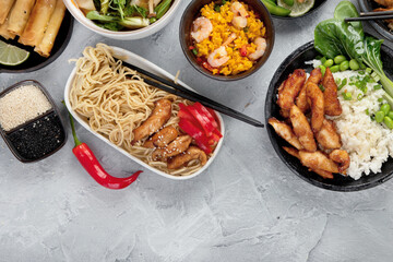 Assorted asian dishes and snacks on dark gray background. Traditional food concept.