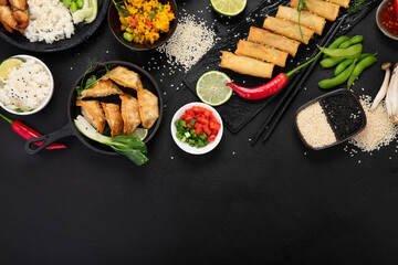Assorted asian dishes and snacks on black background. Traditional food concept.