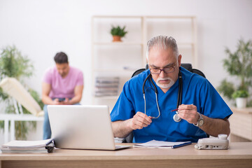 Young male patient visiting old male doctor